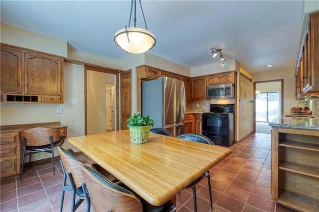 dining area with dark tile patterned flooring and sink