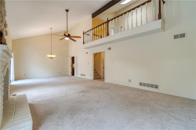 unfurnished living room featuring ceiling fan, carpet floors, a fireplace, and high vaulted ceiling