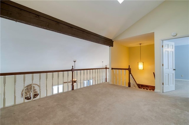 unfurnished room featuring beamed ceiling, carpet, and high vaulted ceiling