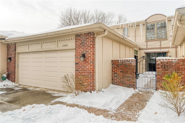 view of snow covered exterior featuring a garage