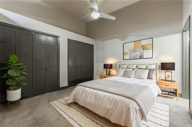 bedroom with carpet, two closets, and ceiling fan