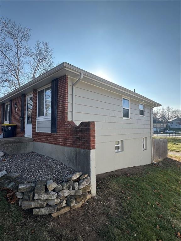 view of side of home featuring a yard