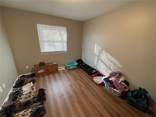 miscellaneous room with hardwood / wood-style flooring and a textured ceiling