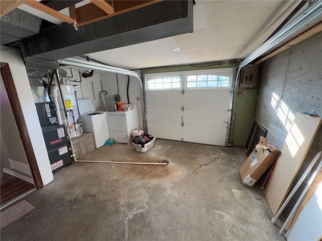 garage with water heater and washing machine and clothes dryer