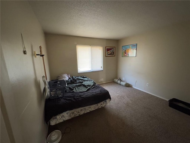 bedroom featuring a textured ceiling and carpet flooring