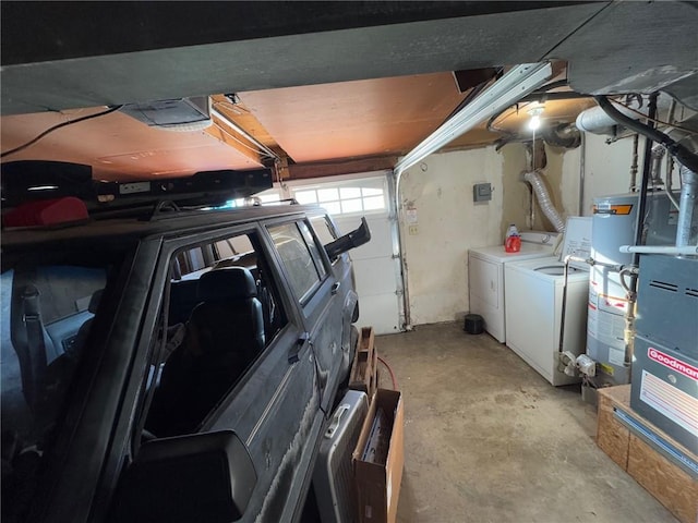 garage with a garage door opener and washer and clothes dryer