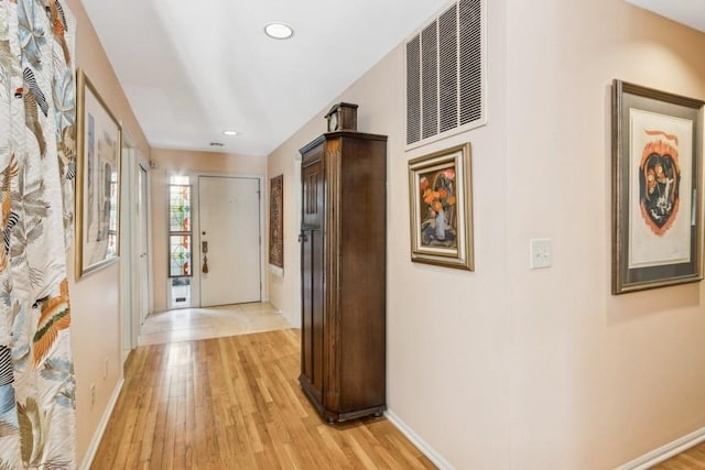 corridor with light hardwood / wood-style flooring