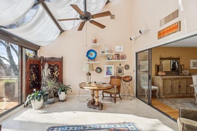 sunroom featuring ceiling fan