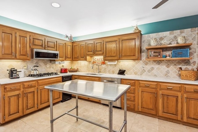 kitchen featuring sink, ceiling fan, light tile patterned floors, tasteful backsplash, and stainless steel appliances