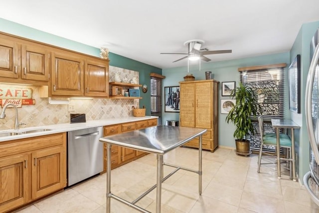 kitchen featuring ceiling fan, sink, backsplash, light tile patterned floors, and appliances with stainless steel finishes