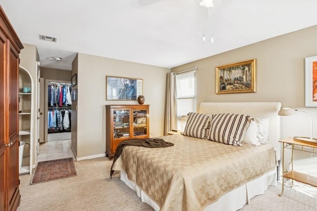 bedroom featuring light carpet, a closet, and ceiling fan