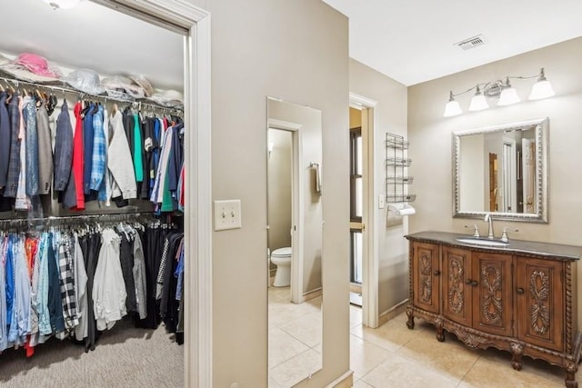 bathroom featuring tile patterned floors, vanity, and toilet