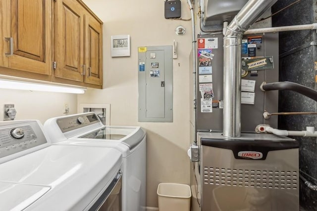 laundry area featuring cabinets, independent washer and dryer, and electric panel