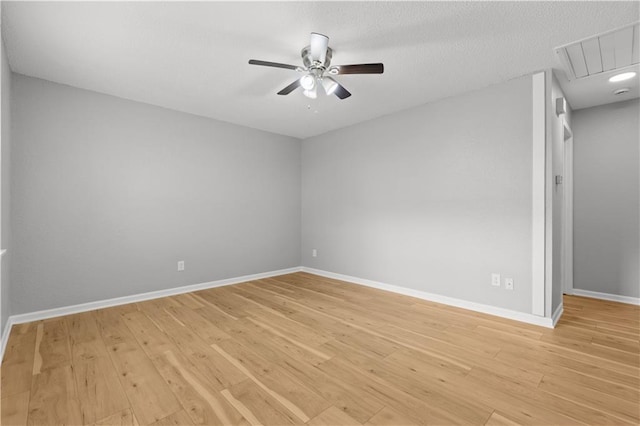 spare room featuring ceiling fan, light hardwood / wood-style floors, and a textured ceiling