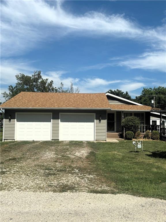 single story home with a front yard and a garage