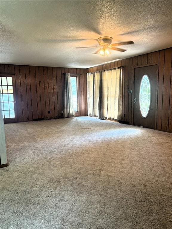 carpeted entrance foyer with ceiling fan