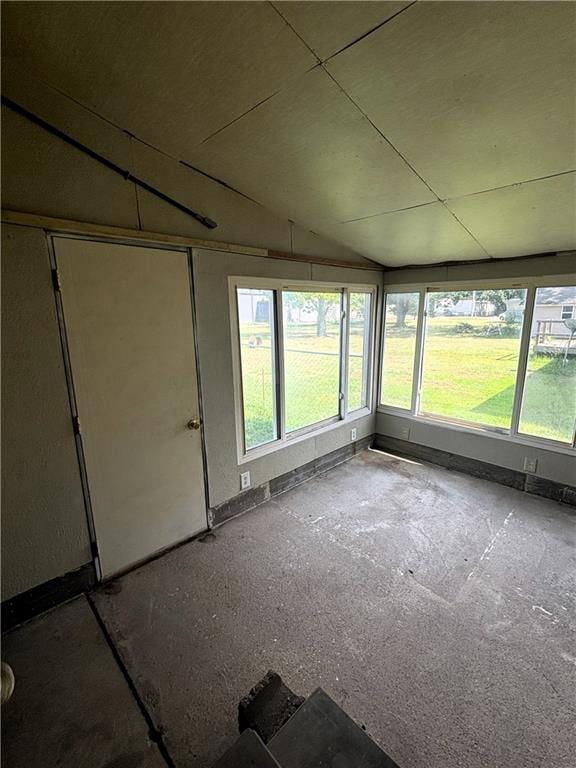 unfurnished sunroom with lofted ceiling