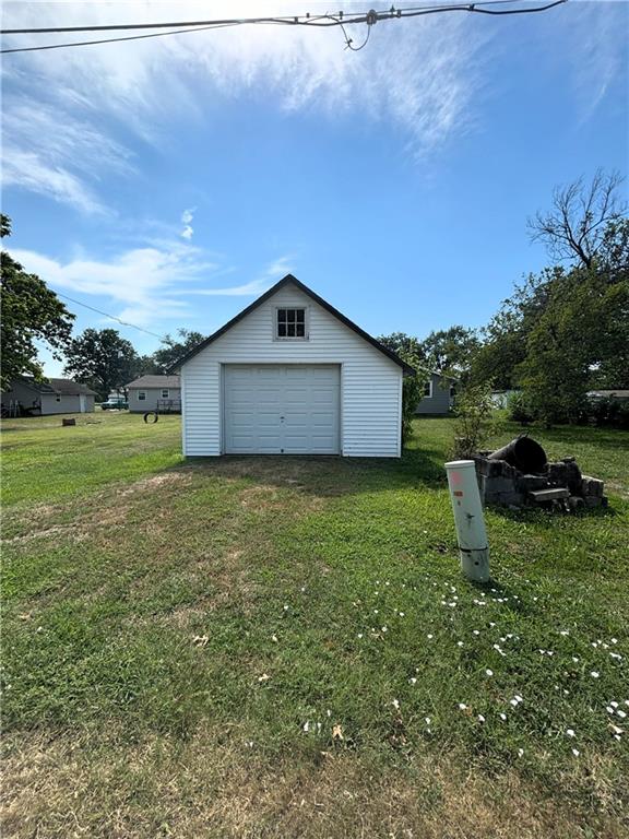 garage featuring a lawn