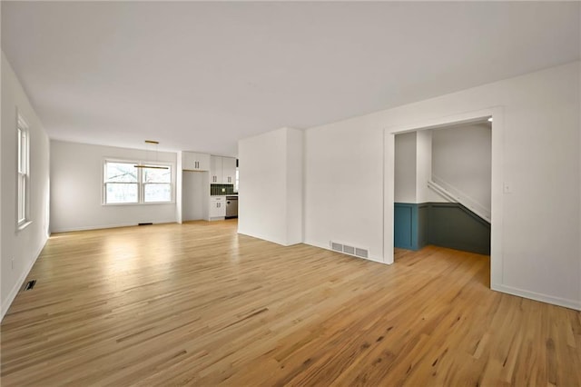 unfurnished living room with light wood-type flooring