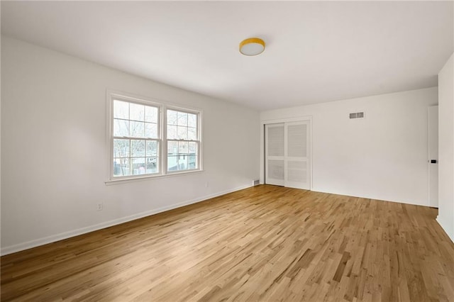 spare room featuring hardwood / wood-style floors