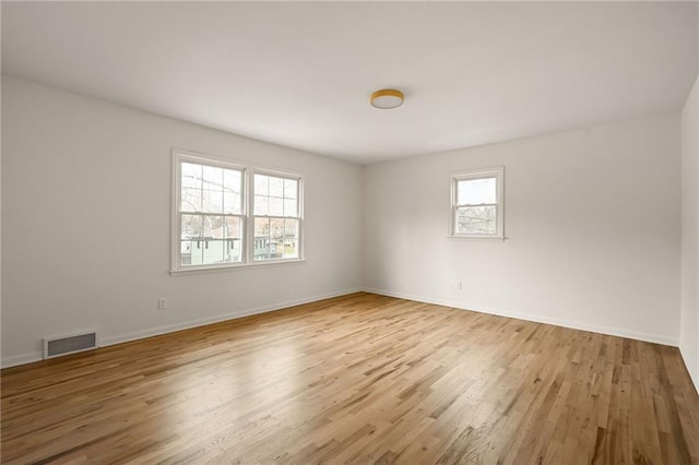 empty room with light hardwood / wood-style floors