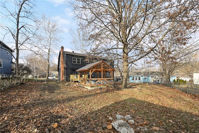 back of house with a wooden deck