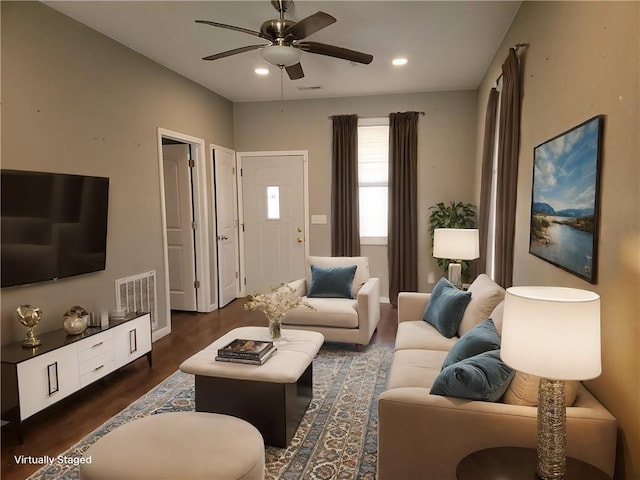 living room featuring dark hardwood / wood-style flooring and ceiling fan