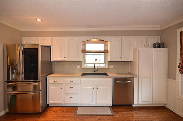 kitchen featuring dark wood-type flooring, appliances with stainless steel finishes, sink, and white cabinets