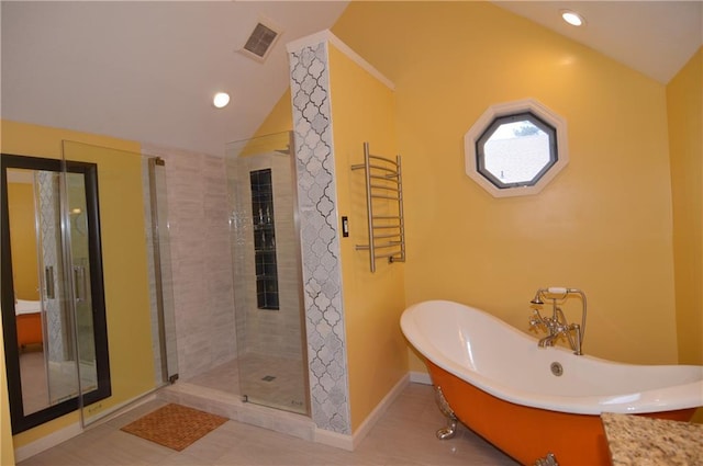 bathroom with plus walk in shower, lofted ceiling, and tile patterned floors