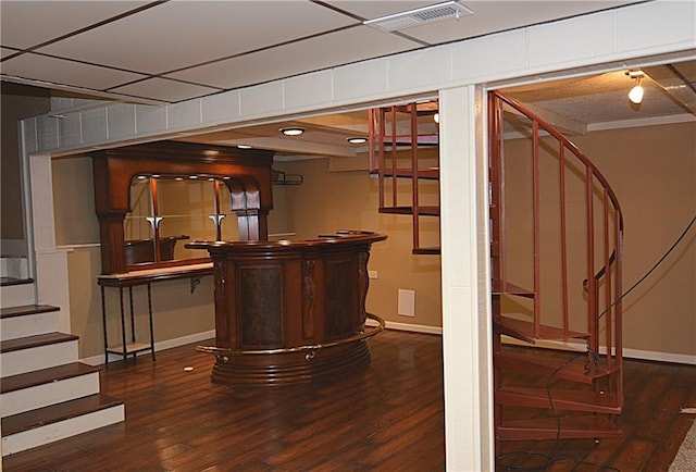 bar with dark hardwood / wood-style flooring