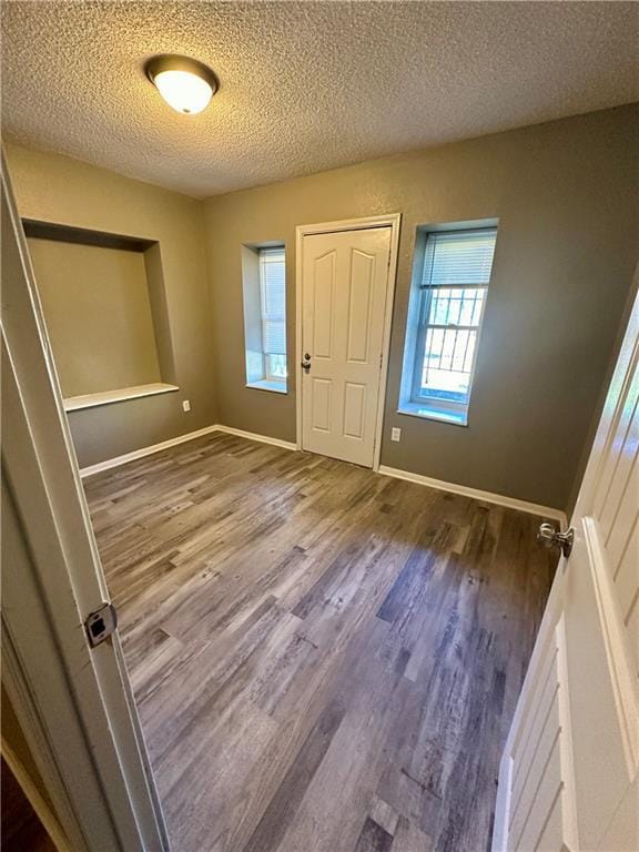 entryway featuring hardwood / wood-style floors and a textured ceiling