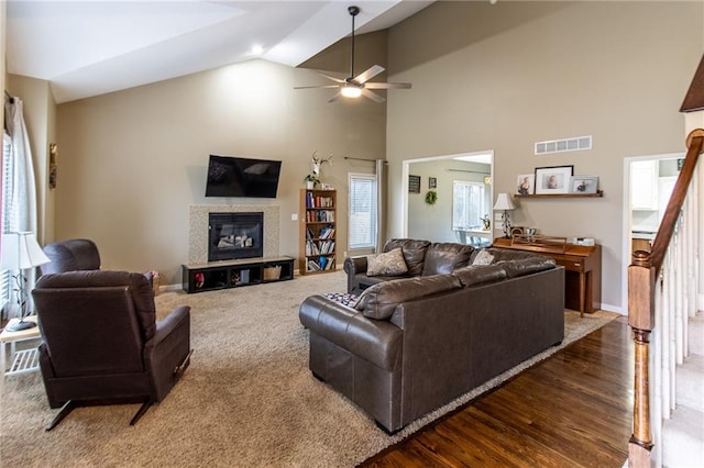 living room with dark hardwood / wood-style flooring, high vaulted ceiling, and ceiling fan