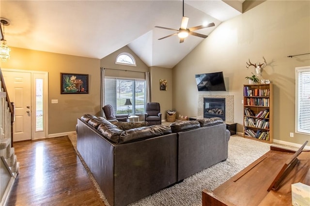 living room featuring dark hardwood / wood-style floors, ceiling fan, and lofted ceiling