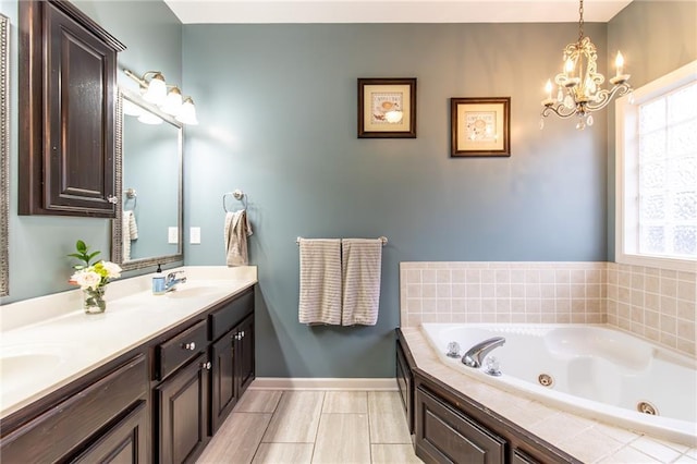 bathroom featuring a bathing tub, vanity, and a chandelier