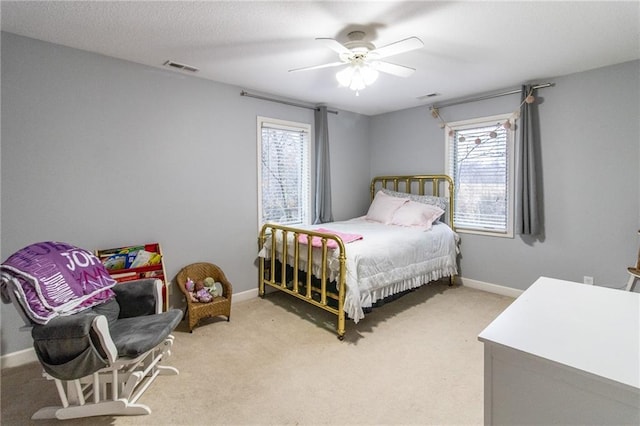 bedroom with ceiling fan and light carpet