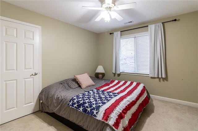 bedroom with ceiling fan and light colored carpet