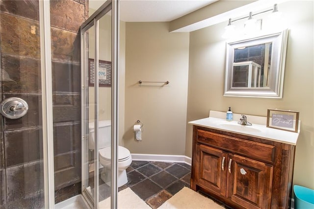 bathroom featuring walk in shower, vanity, and toilet