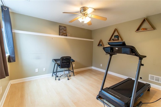 exercise area featuring hardwood / wood-style floors and ceiling fan