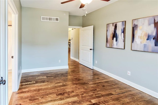 unfurnished room featuring dark hardwood / wood-style floors and ceiling fan