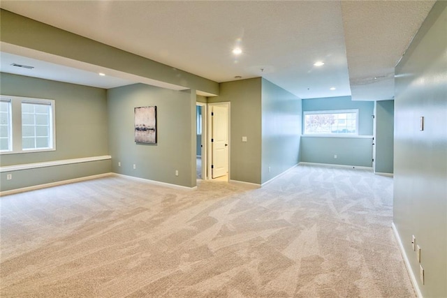 unfurnished room with light colored carpet