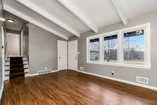 interior space featuring vaulted ceiling with beams and dark hardwood / wood-style flooring