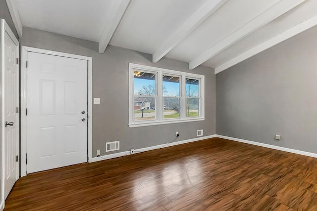 foyer entrance with beam ceiling and dark hardwood / wood-style flooring