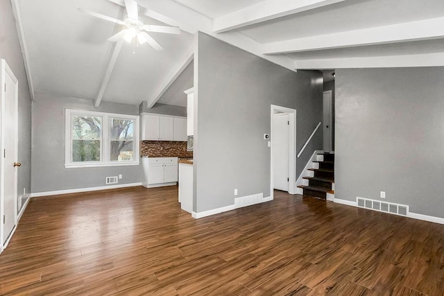 unfurnished living room with vaulted ceiling with beams, ceiling fan, and dark hardwood / wood-style floors