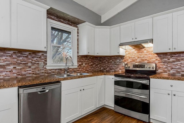 kitchen with white cabinets, stainless steel appliances, vaulted ceiling, and sink