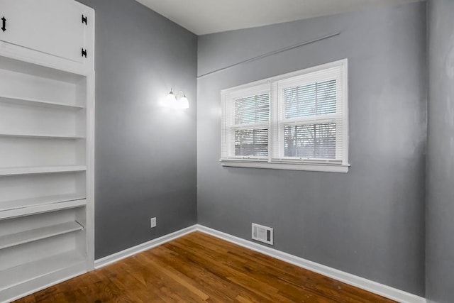 empty room with wood-type flooring