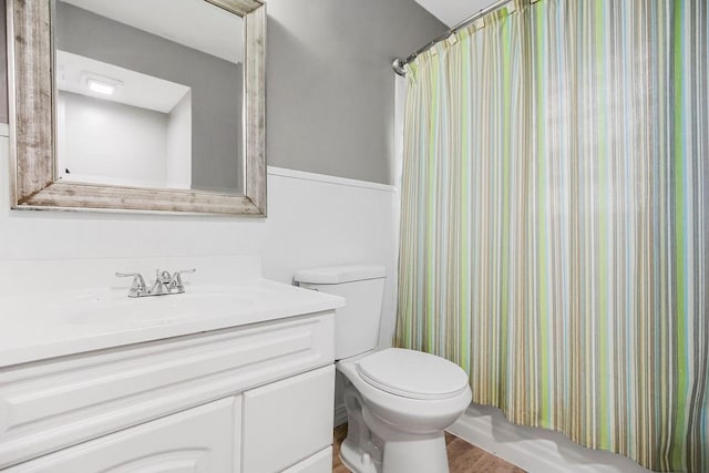 full bathroom with wood-type flooring, vanity, toilet, and shower / bath combination with curtain