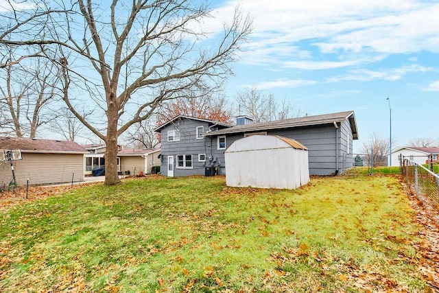 back of property featuring a shed and a yard