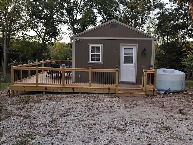 rear view of house with a wooden deck