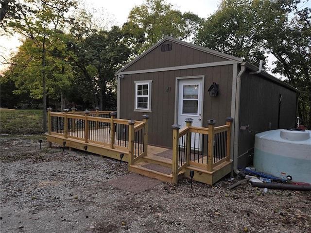 back of house featuring a wooden deck