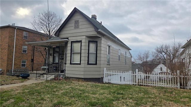 view of side of home with a lawn